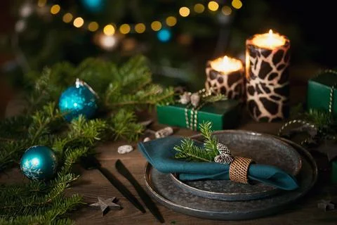 Christmas table setting with empty black ceramic plate, fir tree branches Stock Photos