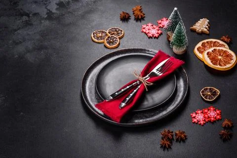 Christmas table setting with empty black ceramic plate, fir tree and black .. Stock Photos