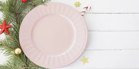 Christmas table setting. empty pink plate fir branches, snowflakes and stars. Stock Photos