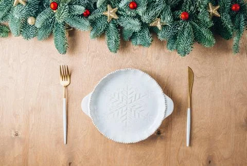 Christmas table setting with empty white ceramic plate, fir tree branch and.. Stock Photos