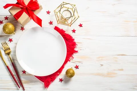 Christmas table setting with holiday decorations and preset box at white wo.. Stock Photos