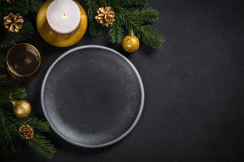 Christmas table setting with holiday decorations at black background. Stock Photos