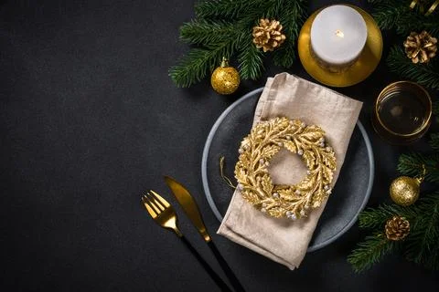 Christmas table setting with holiday decorations at black background. Stock Photos