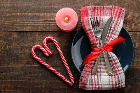 Christmas table setting. Knife, fork and plate with new year decorations. on Stock Photos