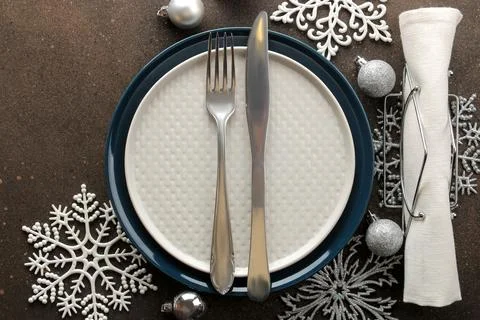 Christmas table setting. Knife, fork and plate with new year decorations. on Stock Photos