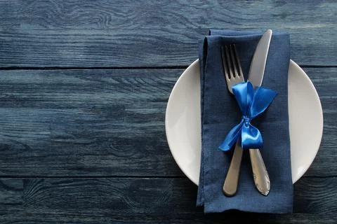 Christmas table setting. Knife, fork and plate with new year decorations. on Stock Photos