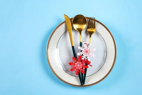 Christmas table setting with modern dishware and decorations on blue backgrou Stock Photos