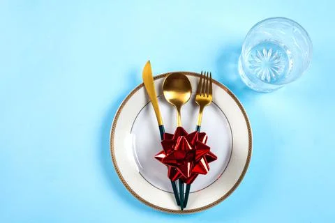 Christmas table setting with modern dishware and decorations on blue backgrou Stock Photos