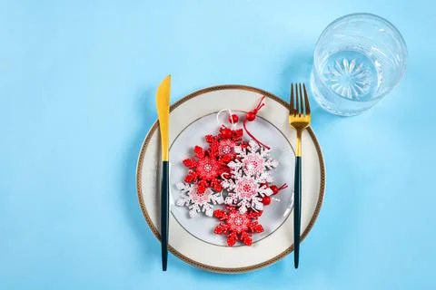 Christmas table setting with modern dishware and decorations on blue backgrou Stock Photos