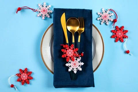 Christmas table setting with modern dishware and decorations on blue backgrou Stock Photos