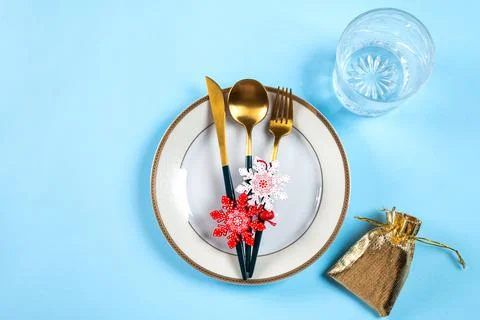 Christmas table setting with modern dishware and decorations on blue backgrou Stock Photos