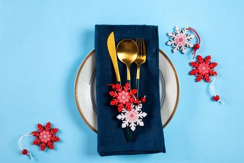 Christmas table setting with modern dishware and decorations on blue backgrou Stock Photos