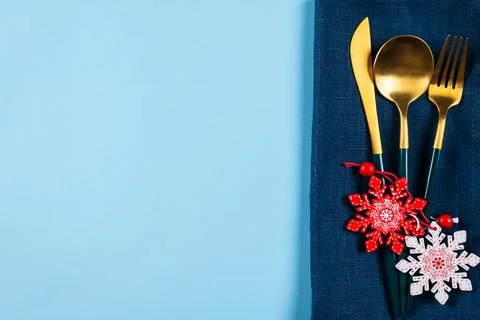 Christmas table setting with modern dishware and decorations on blue backgrou Stock Photos