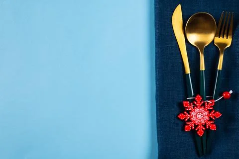 Christmas table setting with modern dishware and decorations on blue backgrou Stock Photos