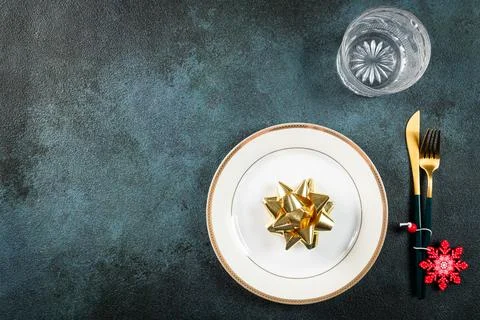 Christmas table setting with modern dishware and decorations on dark backgrou Stock Photos