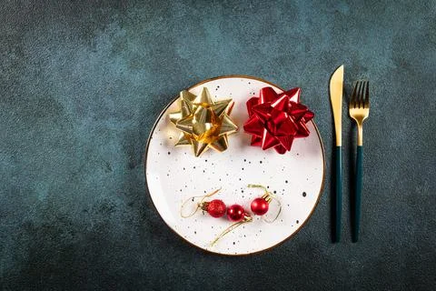 Christmas table setting with modern dishware and decorations on dark backgrou Stock Photos