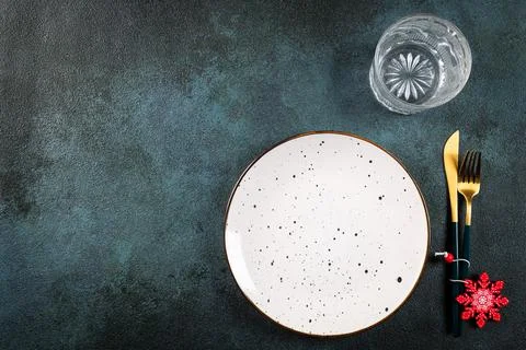 Christmas table setting with modern dishware and decorations on dark backgrou Stock Photos