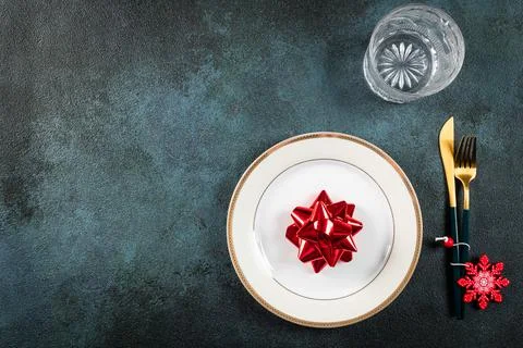 Christmas table setting with modern dishware and decorations on dark backgrou Stock Photos