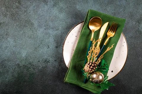 Christmas table setting with modern dishware and decorations on dark backgrou Stock Photos