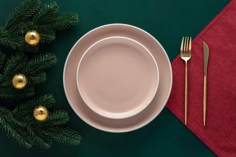 Christmas table setting with New Year decorations. Empty plates and golden .. Stock Photos