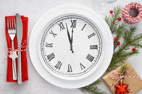 Christmas table setting with plate clock, napkin and cutlery. Stock Photos