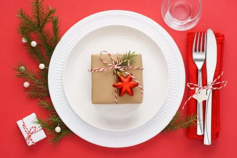 Christmas table setting on red background. Xmas celebration. Stock Photos