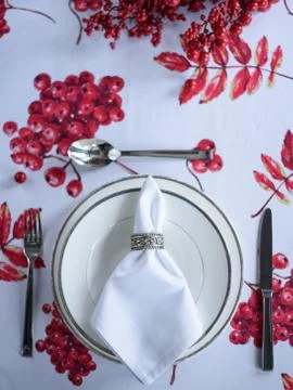 Christmas table setting, tablecloth with a print of rowan branches Stock Photos