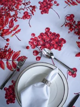 Christmas table setting, tablecloth with a print of rowan branches Stock Photos