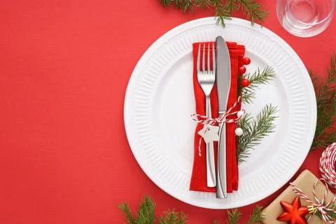 Christmas table setting with white plates, napkin and cutlery. Stock Photos