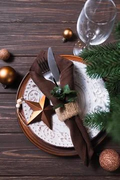 Christmas table setting with winter decor on wooden background. Stock Photos