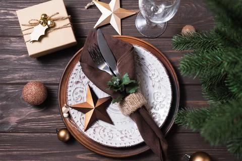Christmas table setting with winter decor on wooden background. Stock Photos