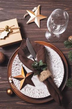 Christmas table setting with winter decor on wooden background. Stock Photos
