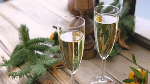 Christmas table at the winter window. Two glasses of champagne, candles in Stock-Footage 143966592