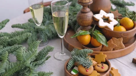 Christmas table at the winter window. Two glasses of champagne, candles in Stock-Footage 143989349