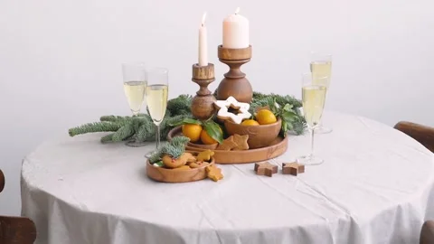 Christmas table at the winter window. Two glasses of champagne, candles in Stock-Footage 143989352