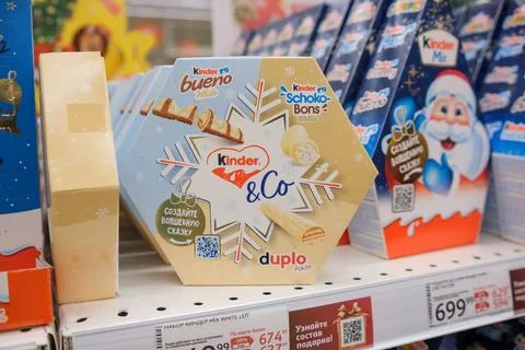 Christmas-themed Candy Display Featuring Kinder Chocolate Products in a Festive Stock Photos
