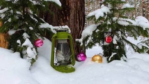 Christmas time concept. Snow falling down in the forest with new year balls. Stock Footage 139798591