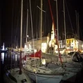 Christmas time in cozy town, view on yachts and boats moored in harbor at night 4k or 4k+ Resolution