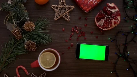 Christmas top view. Man hand using smart phone with green screen. Finger Stock Footage