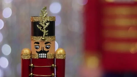 Christmas toy soldier nutcracker, same large figurine behind, bokeh. Stock Footage 259316808