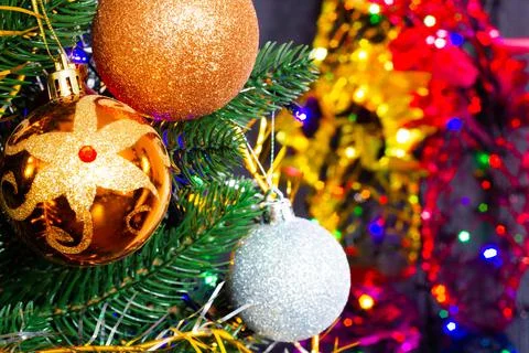Christmas toys on the Christmas tree on the colorful lighting background Stock Photos