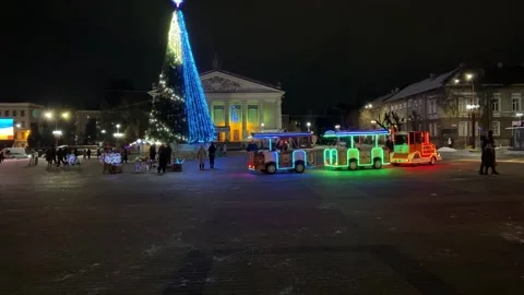 Christmas train circulating in town square at night Stock Footage 301349082