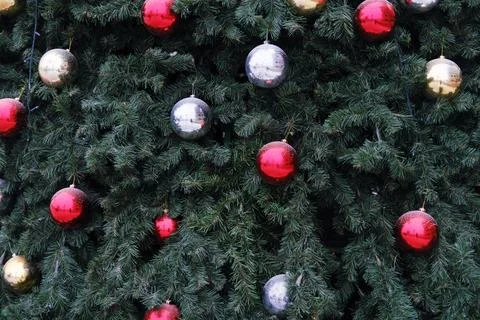 Christmas tree adorned with shiny red, gold, and silver ornaments, creating a Stock Photos