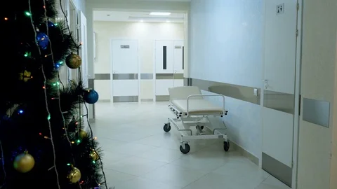 Christmas tree and empty gurney in corridor in medical clinic. 4K Video stock 123214449