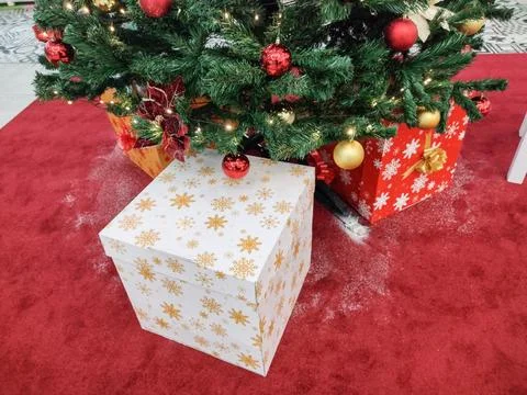 Christmas tree and gift boxes next to it Stock Photos