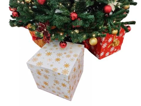 Christmas tree and gift boxes next to it Stock Photos