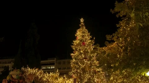 Christmas tree and lights at night in decorated and illuminated central square Stock Footage 258255487