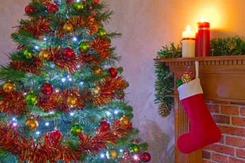 Christmas tree and stocking over the fireplace Stock Photos