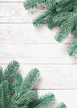 Christmas tree background. Pine branches on white wooden background. Flat lay Stock Photos
