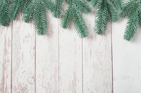 Christmas tree background. Pine branches on white wooden background. Flat lay Stock Photos